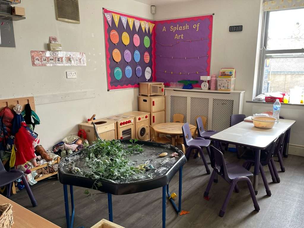 Messy play sensory table and creative art corner in a nursery room at Ducklings Childcare, Huddersfield