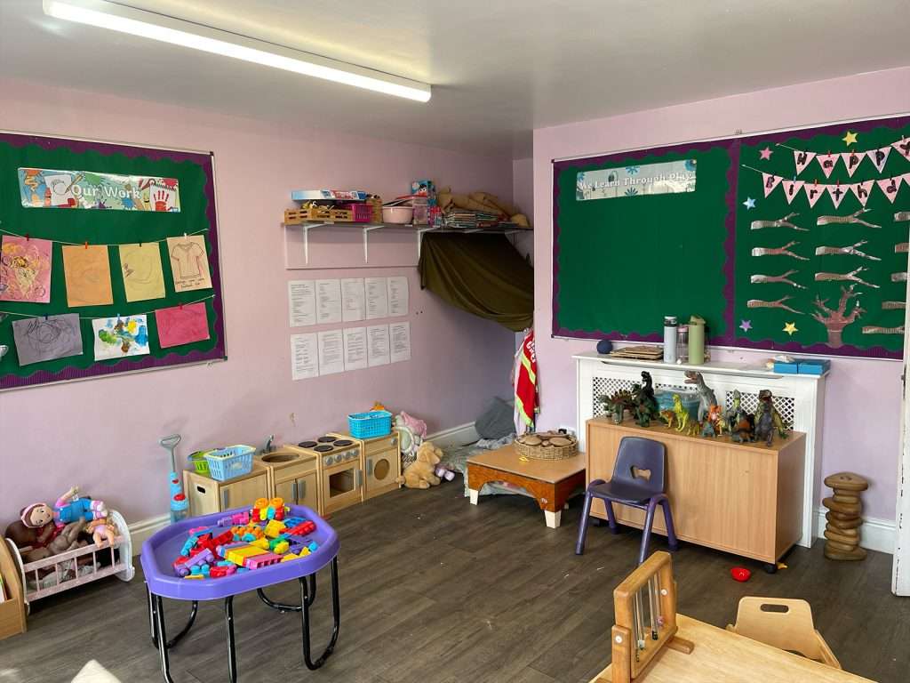 Sensory play table and children's art displays in a nursery classroom at Ducklings Nursery, Huddersfield