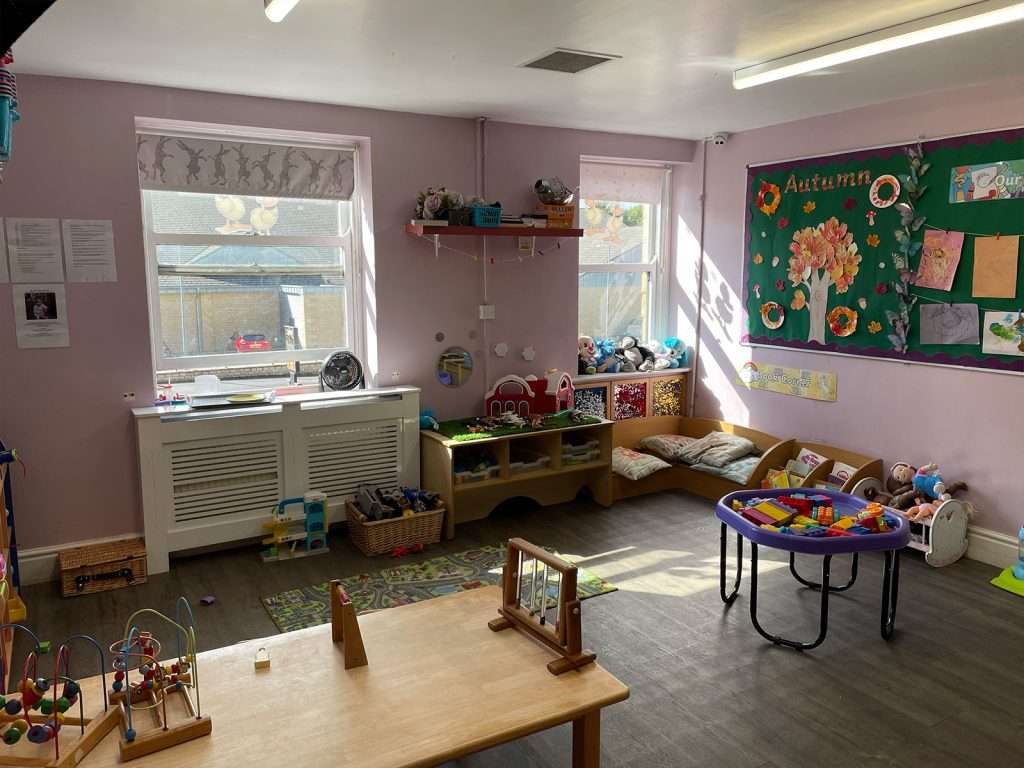 Toy storage units and open play area in a children's nursery room at Ducklings Childcare, Moldgreen, Huddersfield